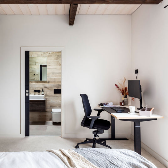 Sit-Stand Solo Desk in a Bedroom
